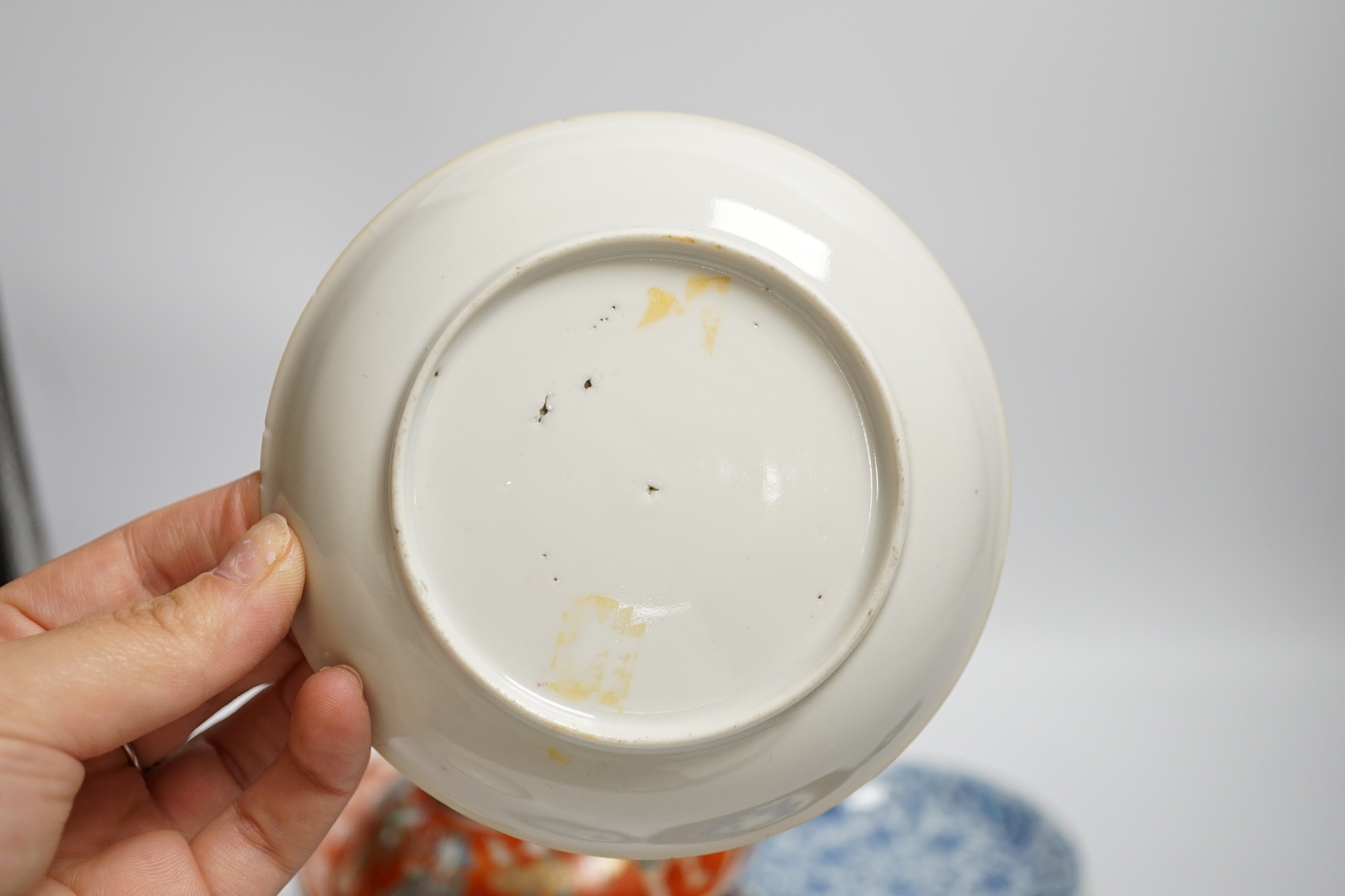 A set of six Chinese blue and white tea bowls and saucers, Kangxi period, a Chinese famille rose tea bowl and saucer, a Batavia ware saucer, both 18th century and Japanese ceramics